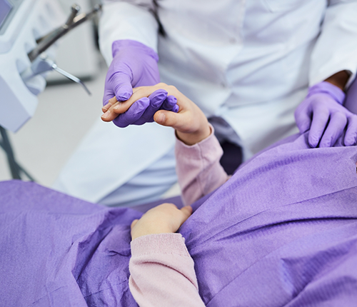 Orthodontist holding a patient's hand