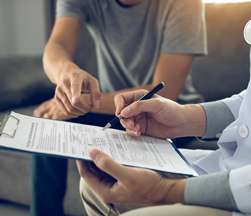 Two people filling out paperwork