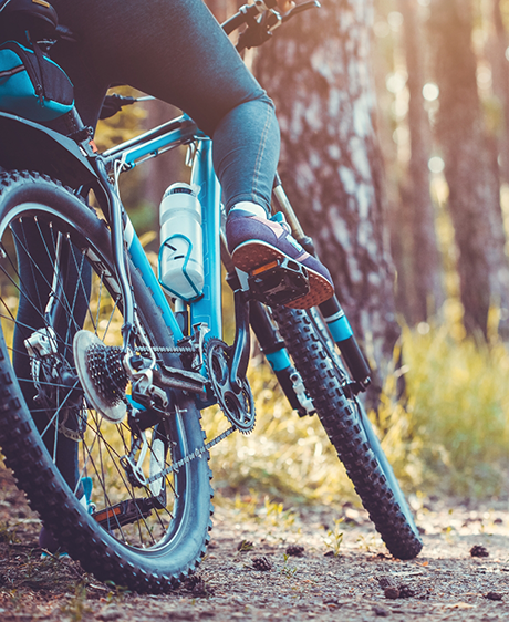 Person riding their bike in the woods