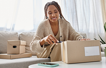 Woman opening a package with a box cutter