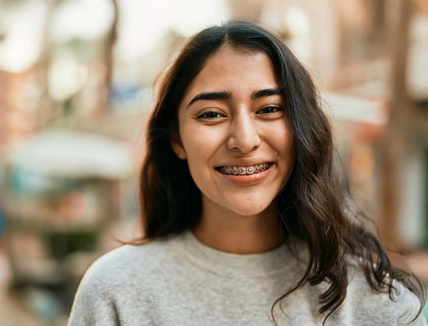 Teenage girl with braces smiling