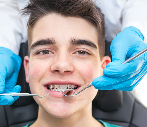 Teenage boy with braces getting a dental exam