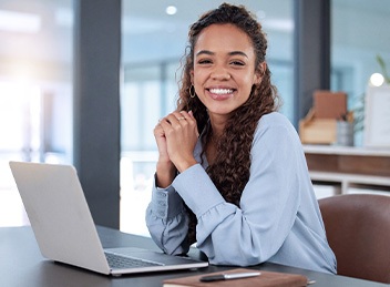 Woman smiling while working in office