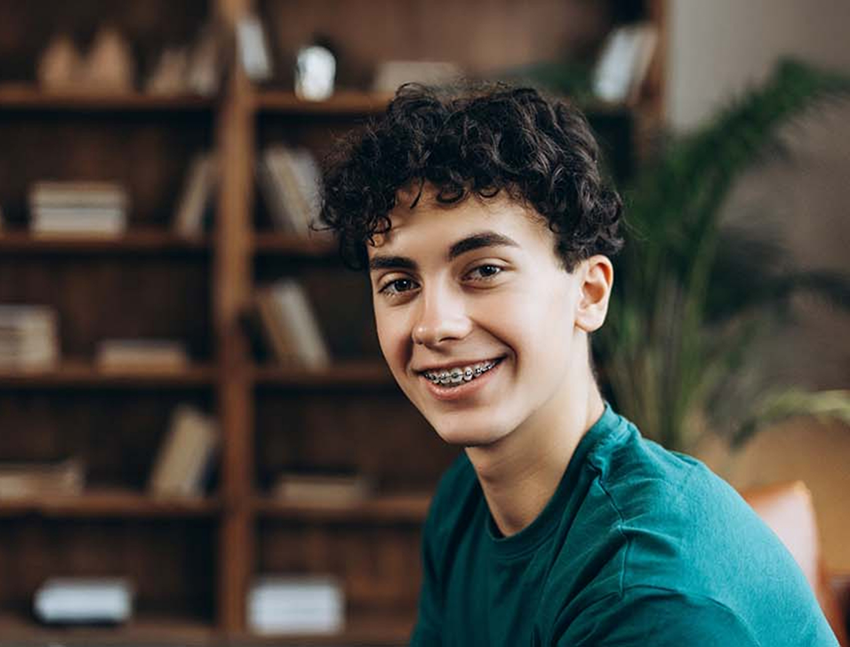 Boy smiling with traditional braces in Bend
