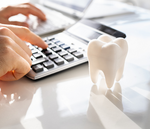 Person typing on a calculator